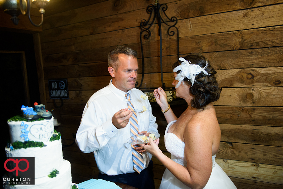 Bride and groom eating cake.