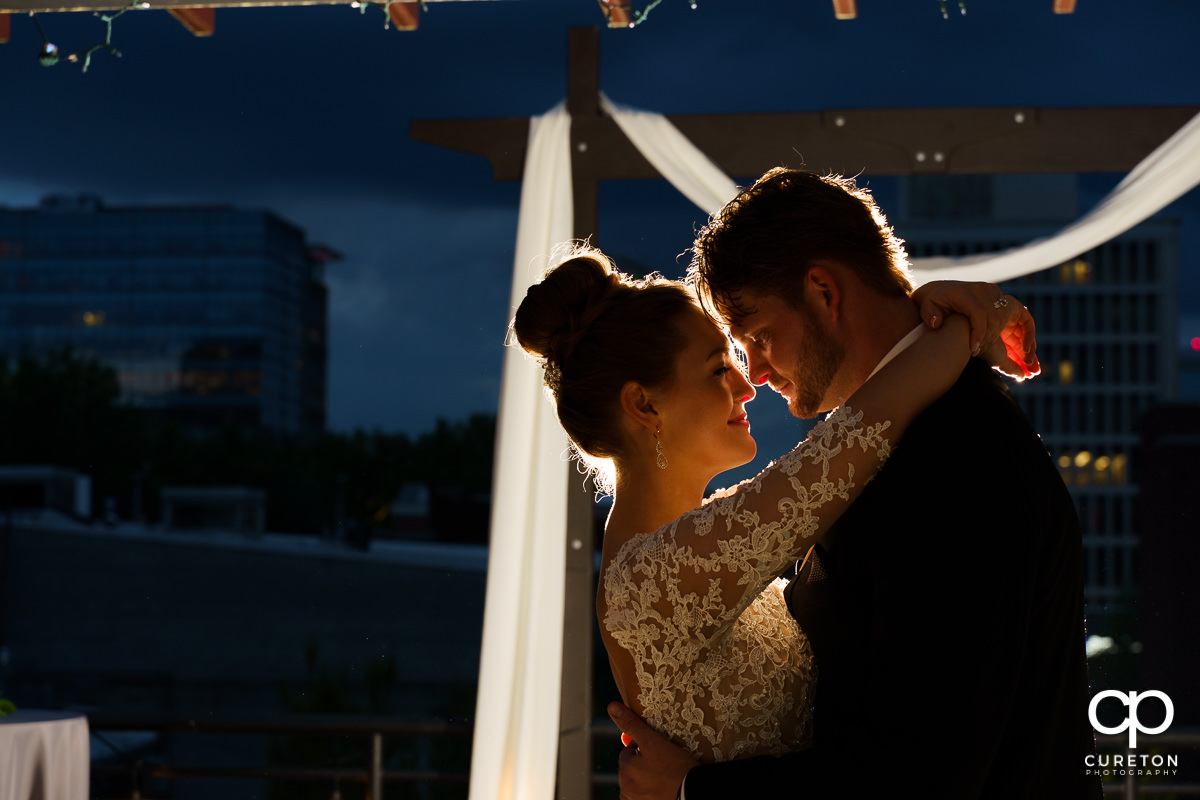 Bride and groom dancing with the skyline in the background after their Loft at Soby's wedding in downtown Greenville,SC.