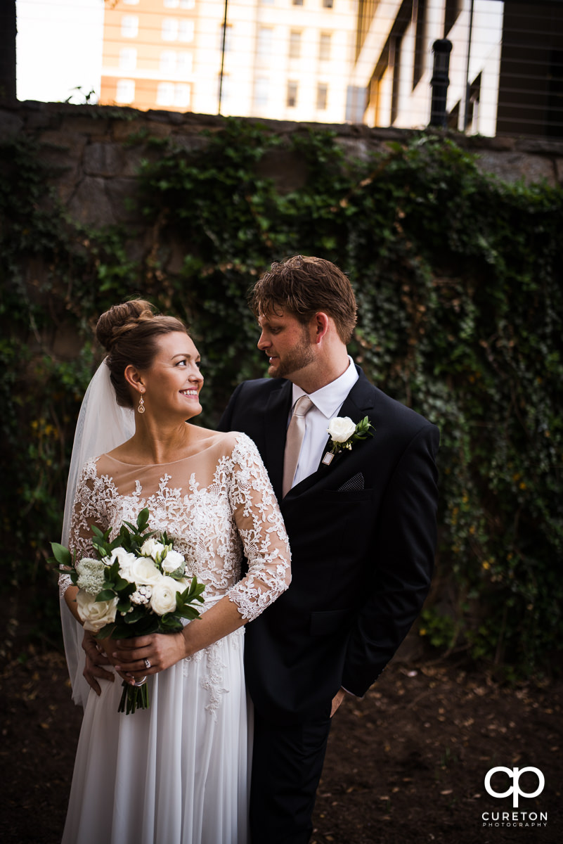 Bride and groom strolling Main Street after their Loft at Soby's wedding in downtown Greenville,SC.