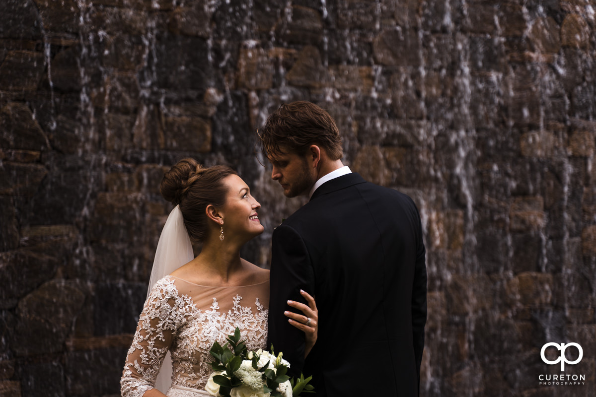 Bride and groom in front of a waterfall after their Loft at Soby's wedding in downtown Greenville,SC.