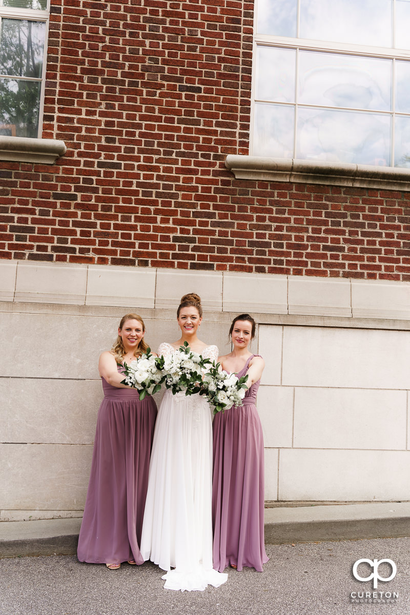 Bride and bridesmaids holding their flowers.