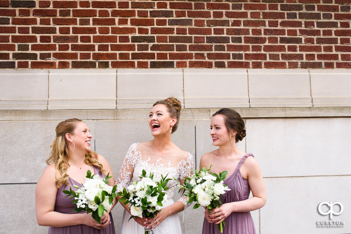 Bride laughing with her bridesmaids before her Loft at Soby's wedding in downtown Greenville,SC.