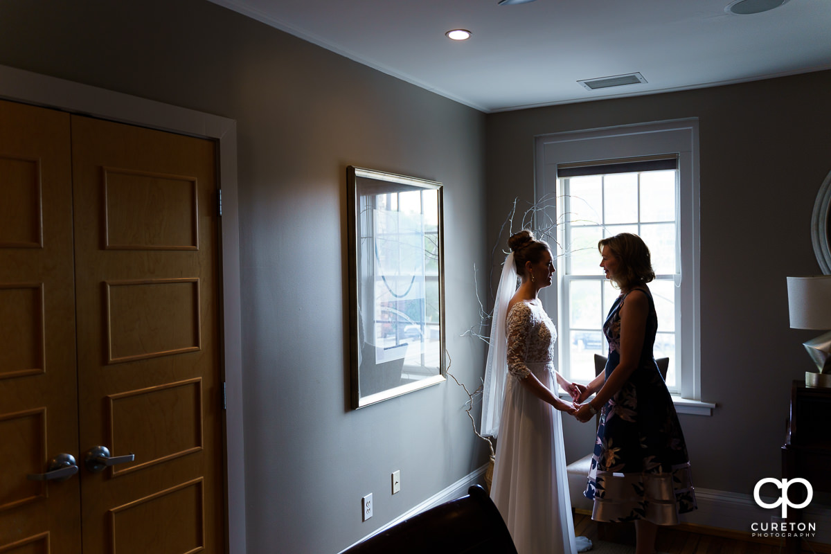 Mother and bride sharing a moment before the wedding.