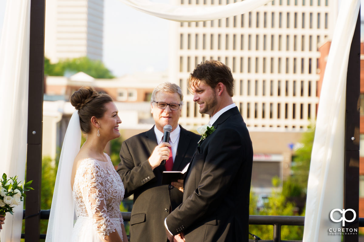 Bride and groom saying their vows on a rooftop in downtown Greenville,SC.