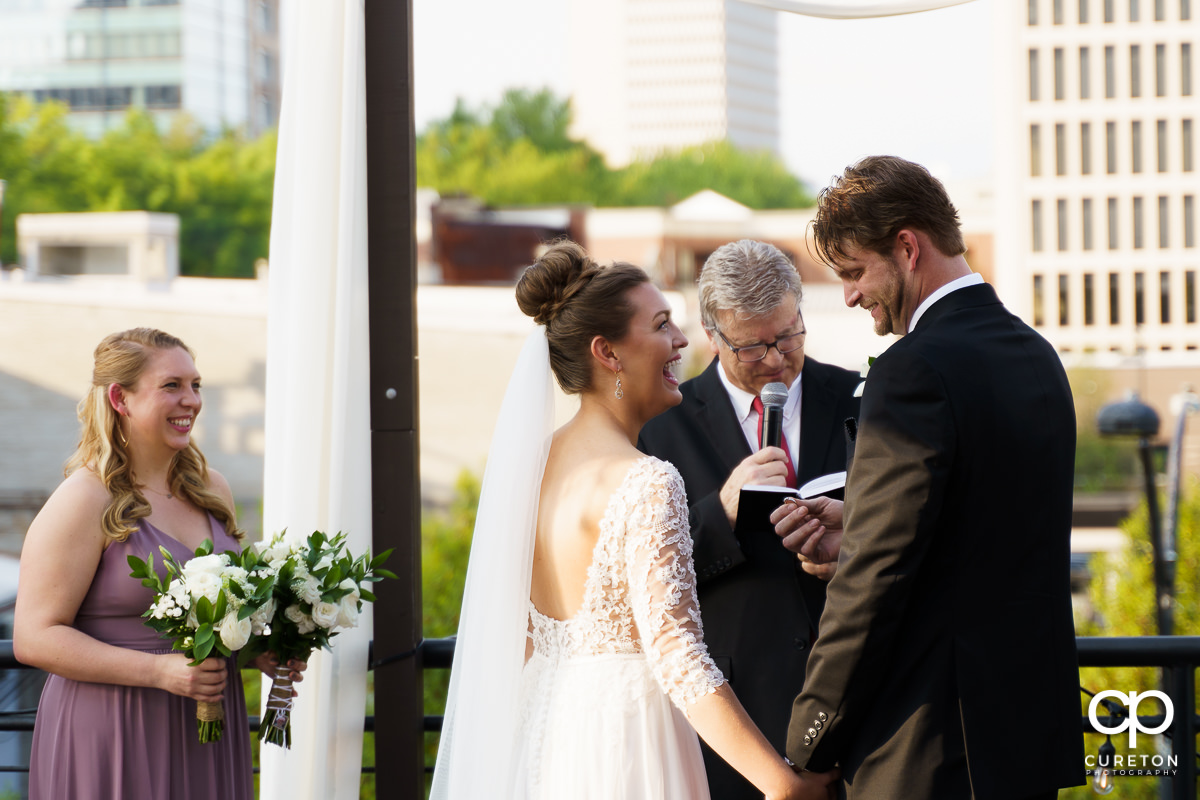 Bride laughing during the wedding ceremony.