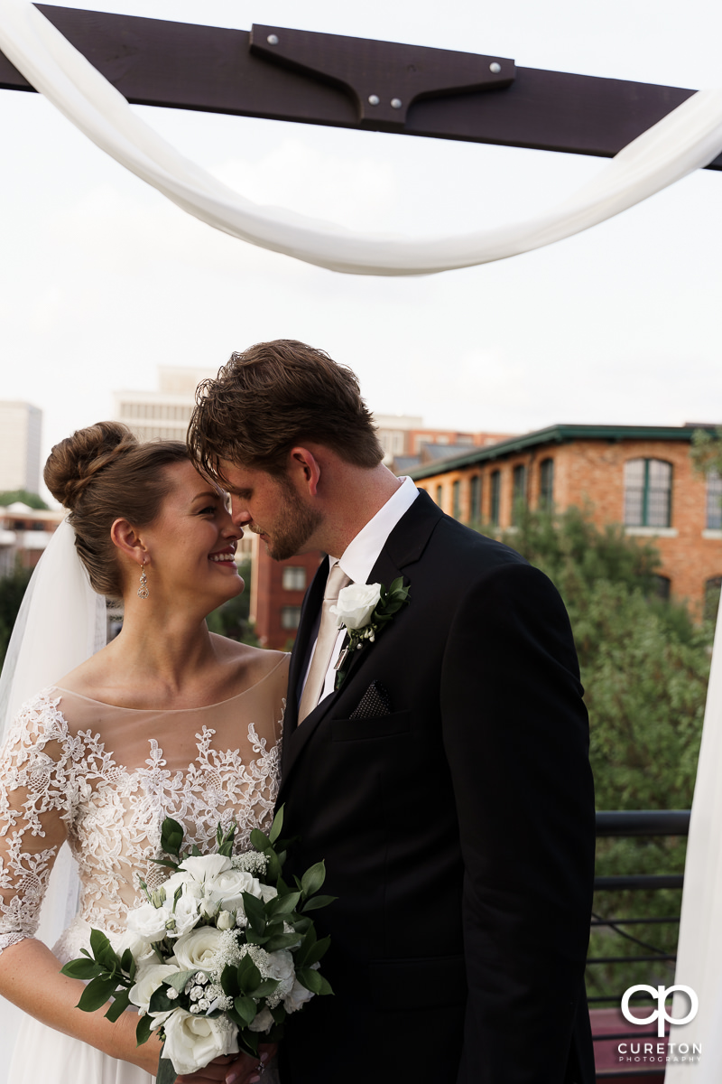 Bride and groom cuddling on teh rooftop after their Loft at Soby's wedding in downtown Greenville,SC.