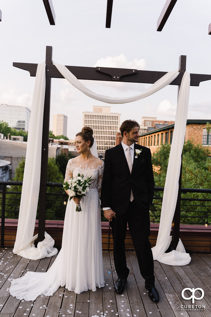 Bride and groom looking into the distance.