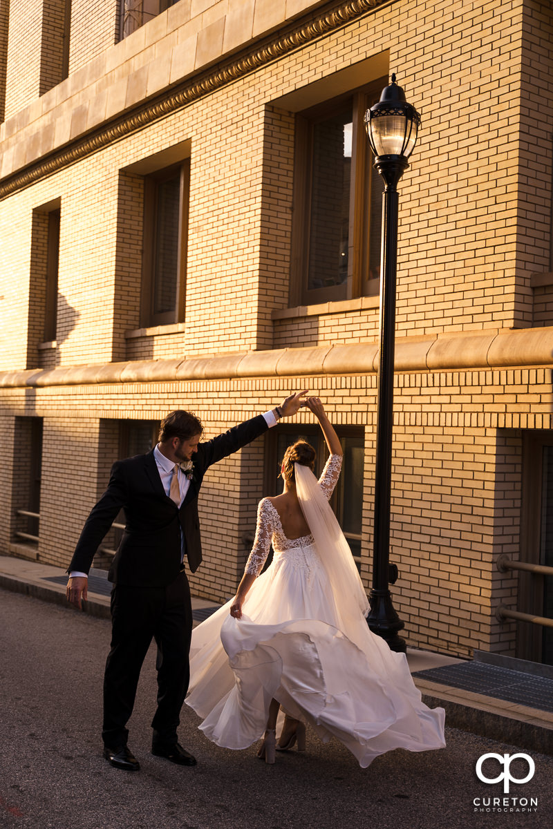 Bride and groom dancing in the streets of Greenville,SC.