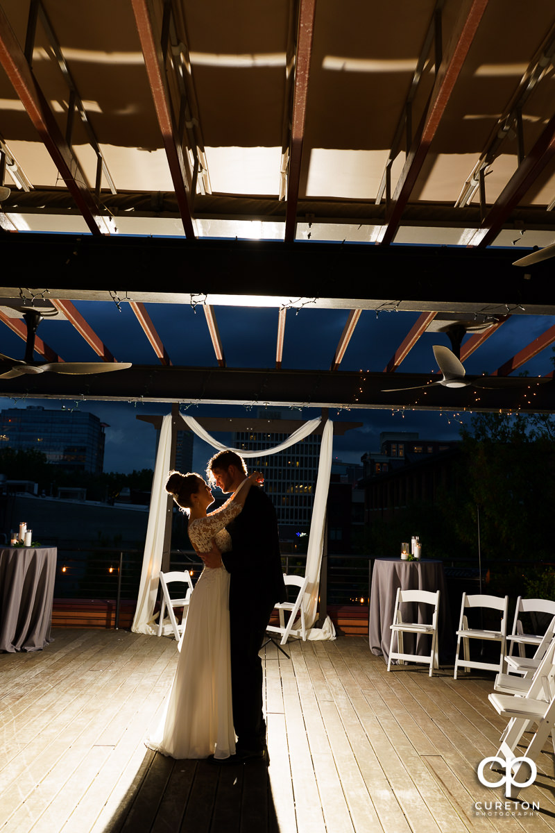 Bride and groom sharing a dance by themselves on a rooftop after their Loft at Soby's wedding in downtown Greenville,SC.