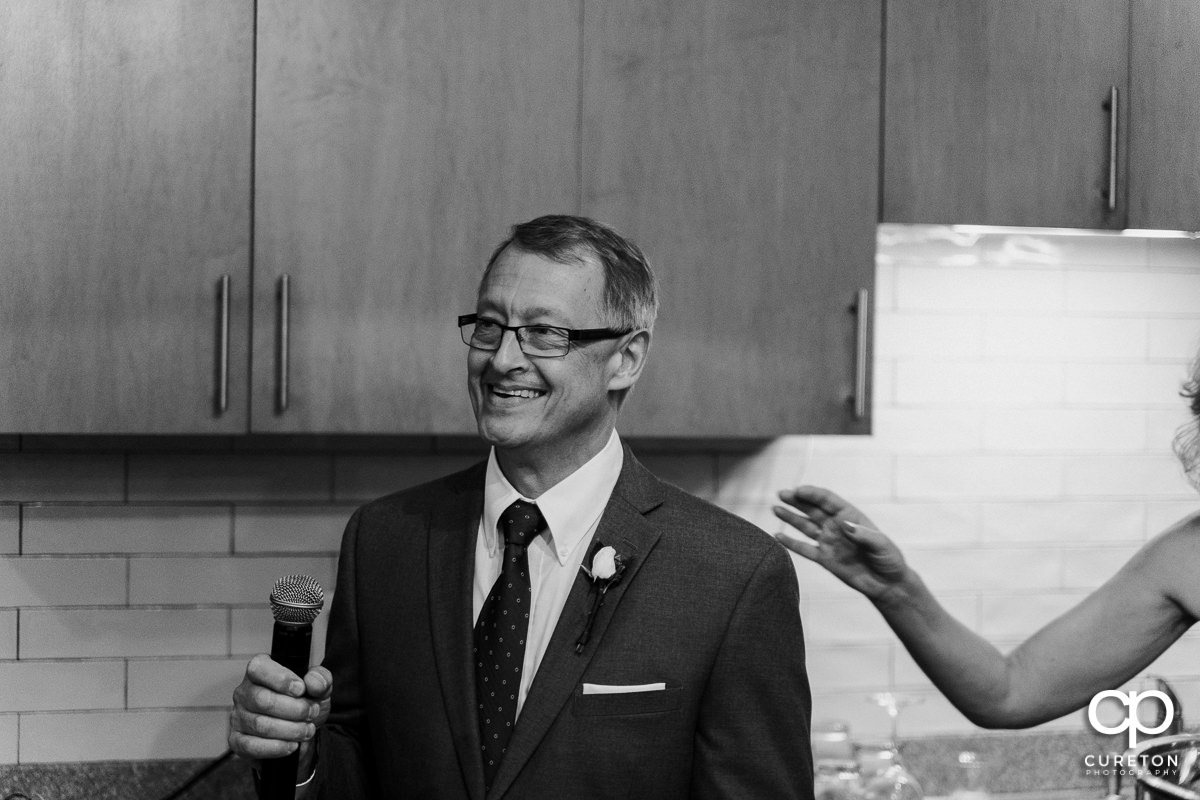 Bride's father giving a speech at the wedding reception.