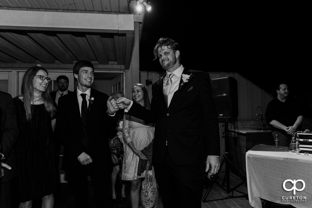 Groom fist bumping his groomsman.