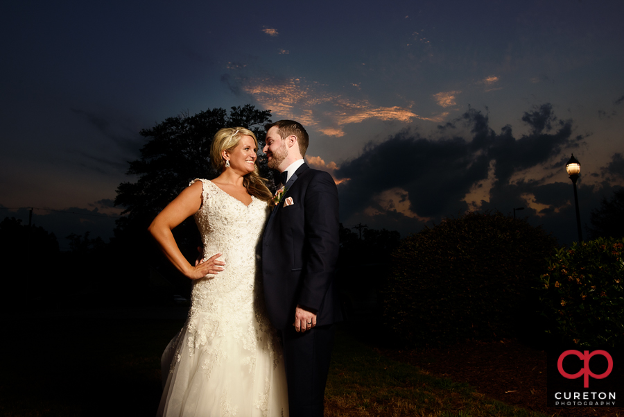 Bride and Groom pose at sunset during thier wedding reception at The Loom at Cotton MIll Place in Simpsonville.