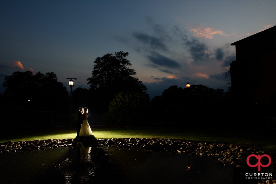 Backlit photo of a bride and groom behind the Loom in Simpsonville,SC.