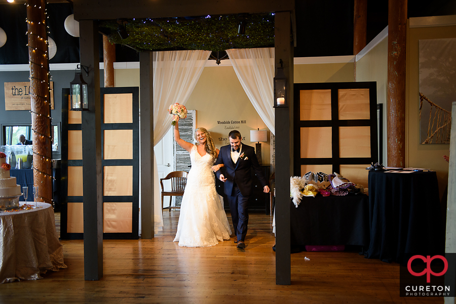 The bride and groom getting introduced.