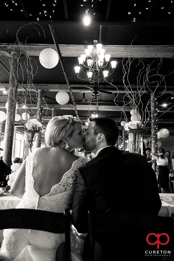 Bride and groom kissing.