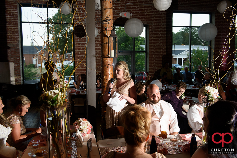 Bridesmaid giving a toast.