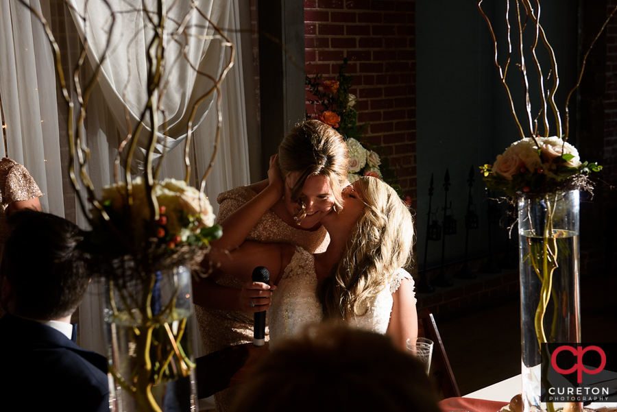 Bride's sisters sing a song for the bride.