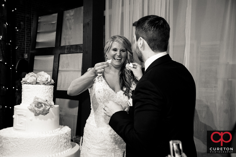 Bride and groom cutting the cake.