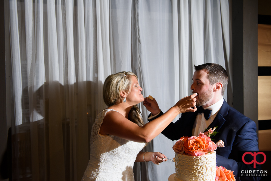 Bride and groom cutting the cake at The Loom.