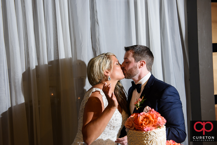 Bride and groom kissing.