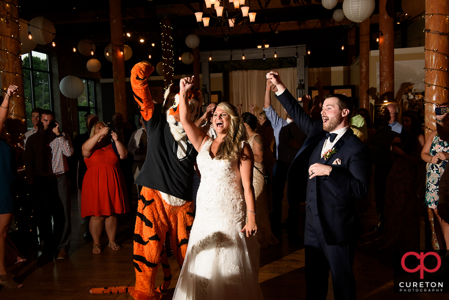 Bride and Groom dance with the Clemson Tiger at their wedding reception at The Loom at Cotton Mill Place.