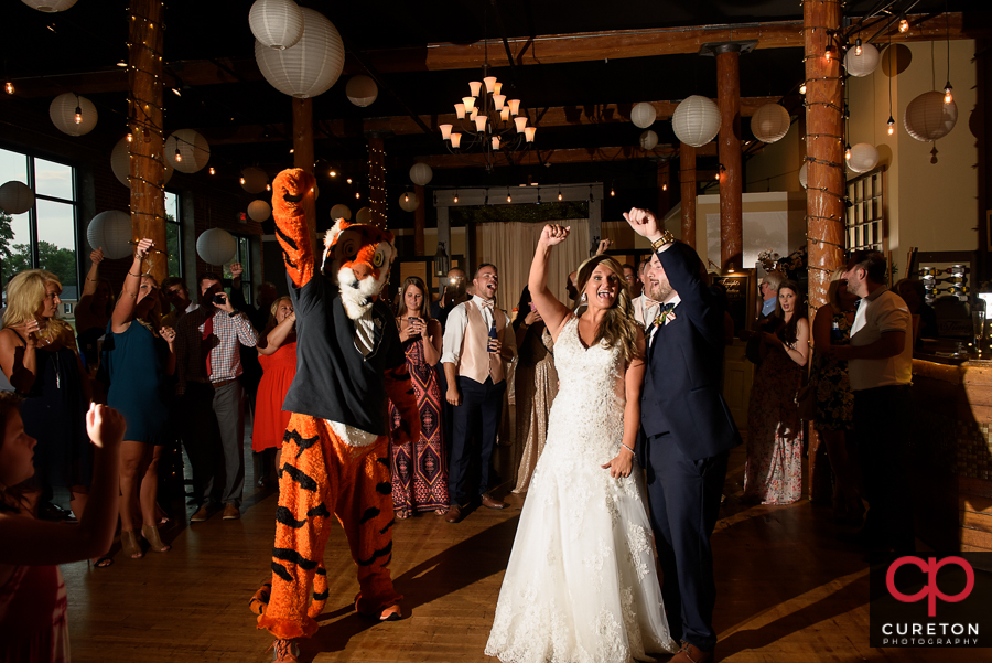 Bride and Groom dance with the Clemson Tiger at their wedding reception at The Loom at Cotton Mill Place.