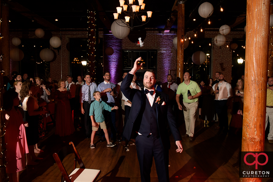 Groom tossing the garter.