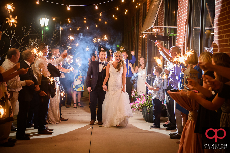 The bride and groom making an epic wedding exit through sparklers at The Loom.