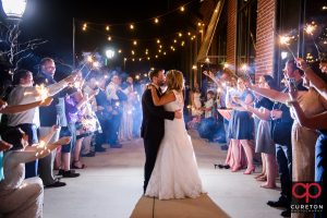 The bride and groom making an epic wedding exit through sparklers at The Loom in Simpsonville.
