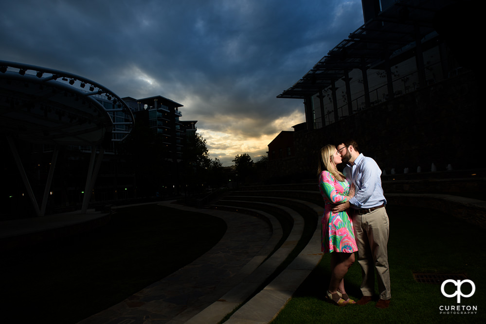Engaged couple kissing during a pre-wedding photo session.