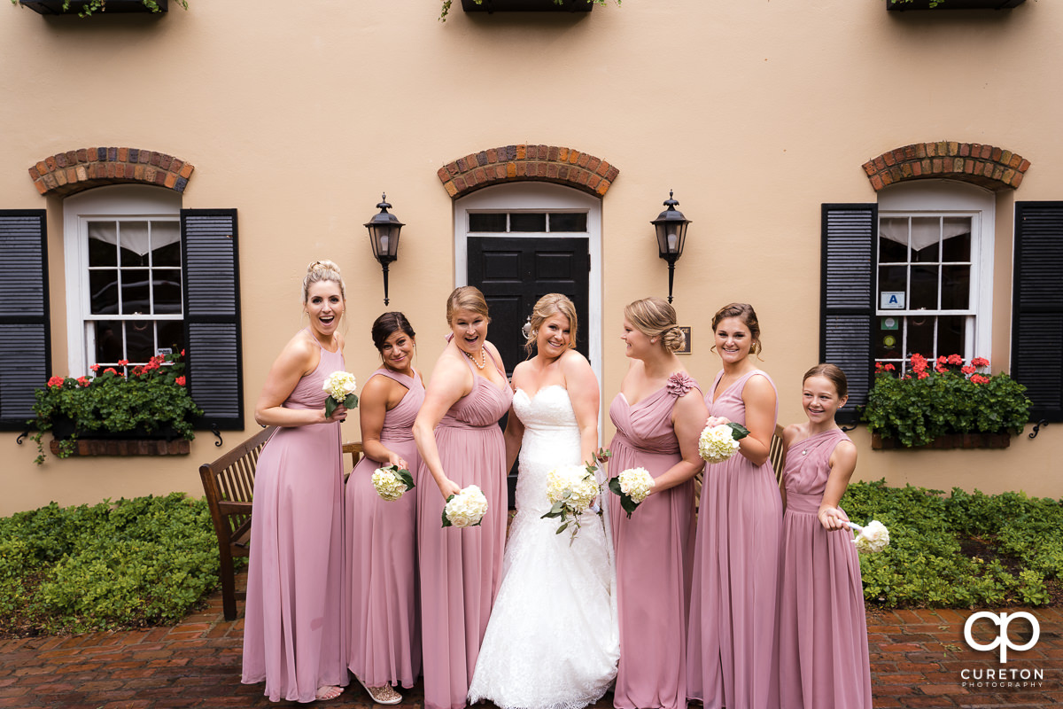 Bride and bridesmaids laughing.