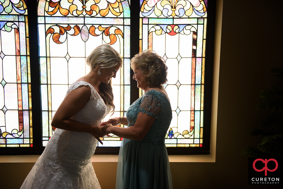 Bride and her mom before their wedding at Mitchell Road Presbyterian Church.