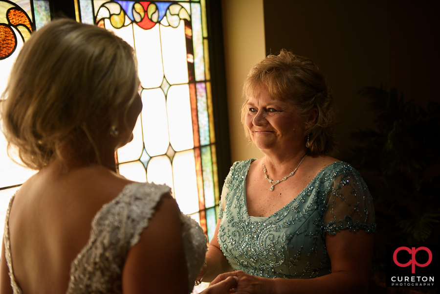 Bride's mom looking at the bride.