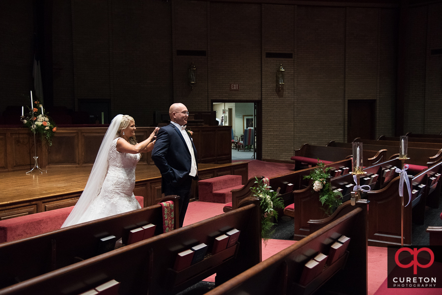 Bride and father first look inside church.