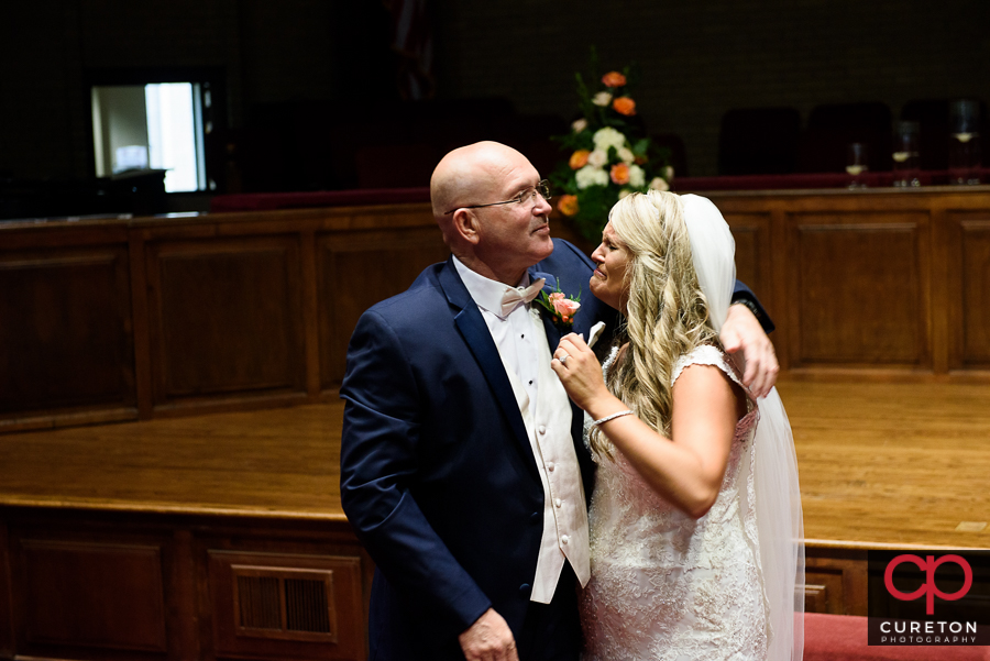 Bride and father first look inside church.