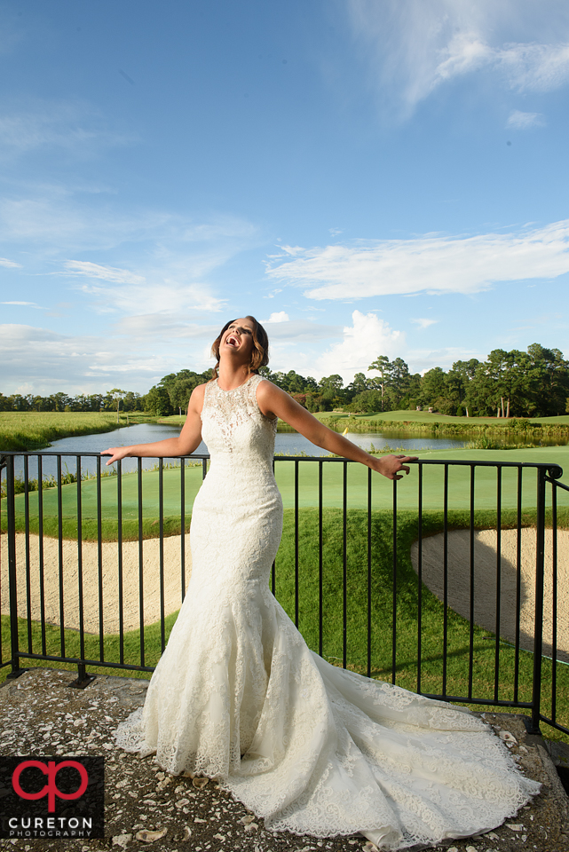 Bride laughing on the golf course.