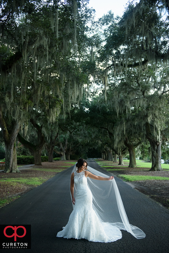 Bride with a long veil during a coastal bridal session.