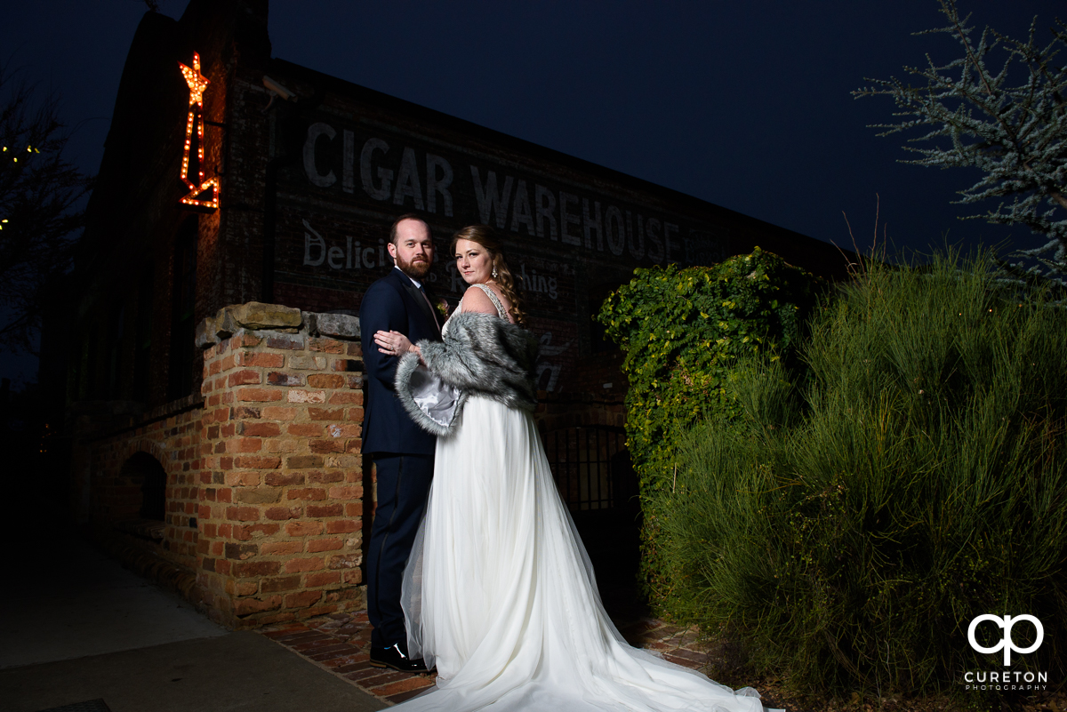 Married couple standing onutside of Teh Old Cigar Warehouse in downtown Greenville,SC.