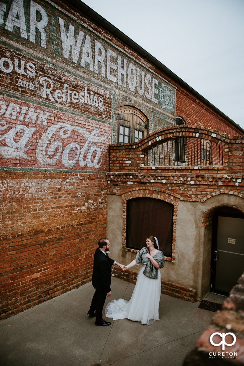 Bride and groom dancing outside of the Old Cigar Warehouse after their wedding.