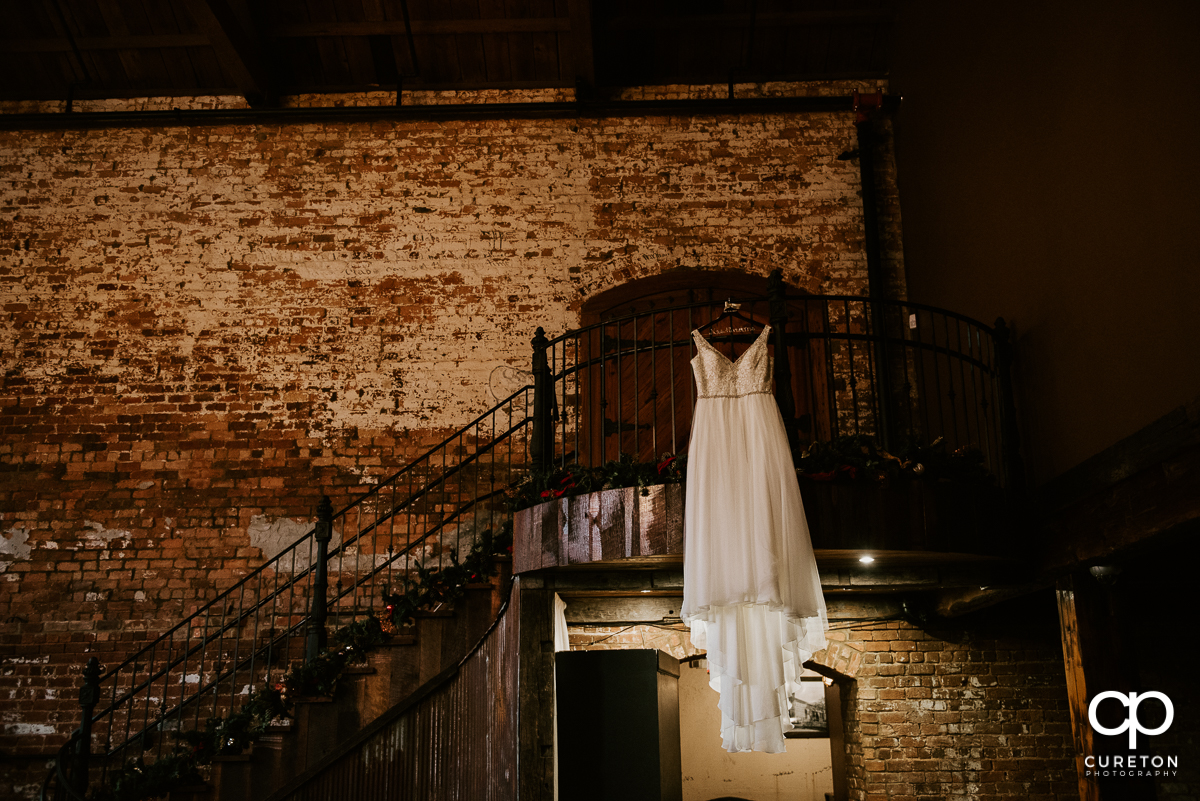 Bride;s dress hanging on the staircase at The Old Cigar Warehouse.