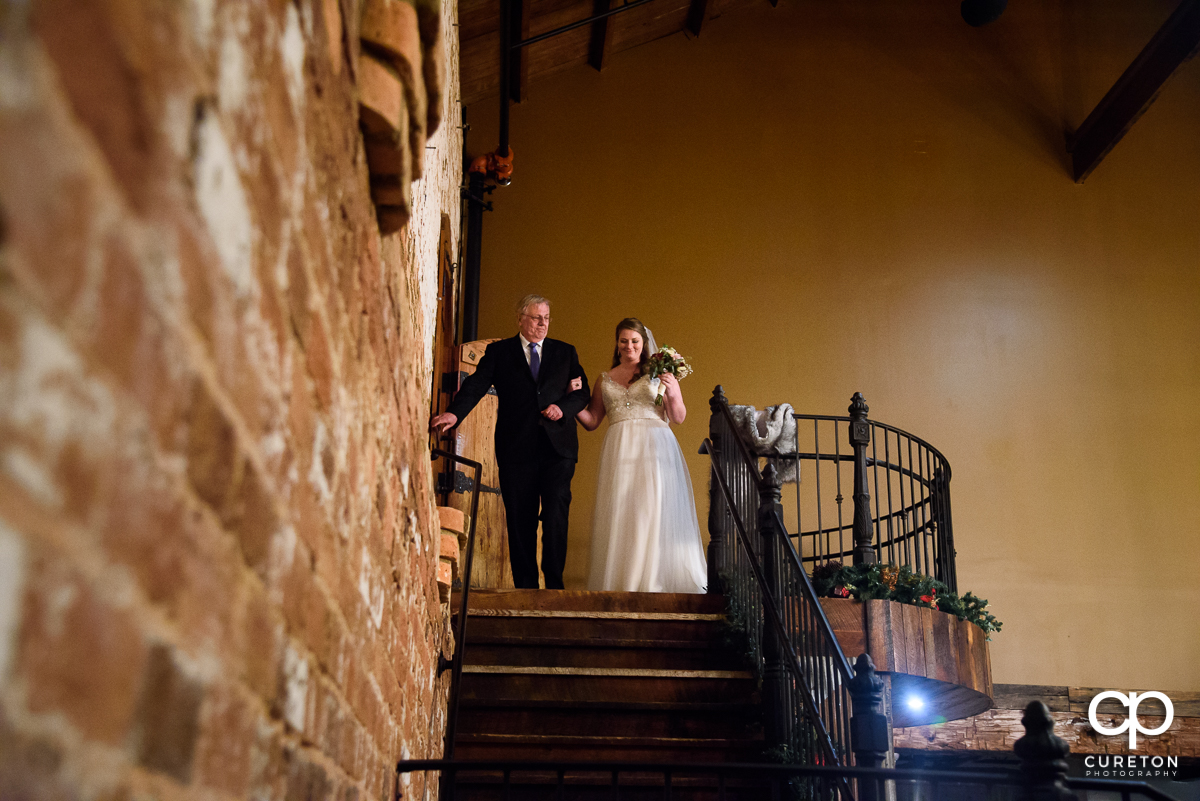 Bride and her dad making a grand entrance down the staircase.