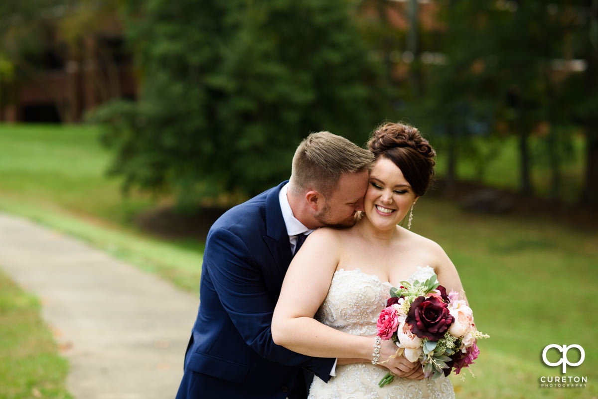 Groom hugging his bride before the wedding ceremony at Noah's Event Venue in Mauldin,SC.