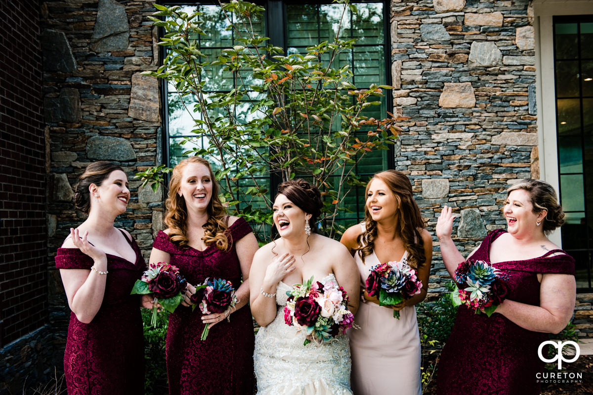 Bride laughing with her bridesmaids before her wedding in Mauldin,SC.