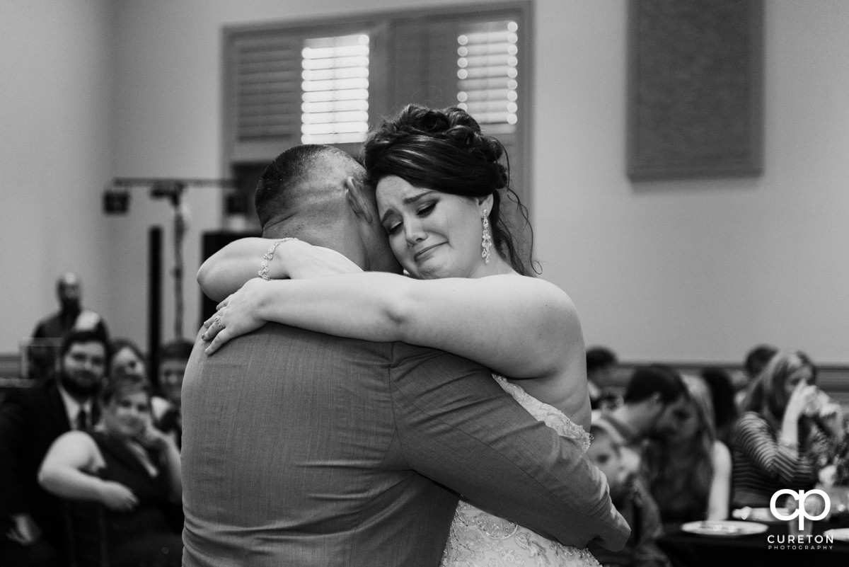 Bride crying after dancing with her dad at her wedding reception at Noah's Event Venue in Mauldin,SC.