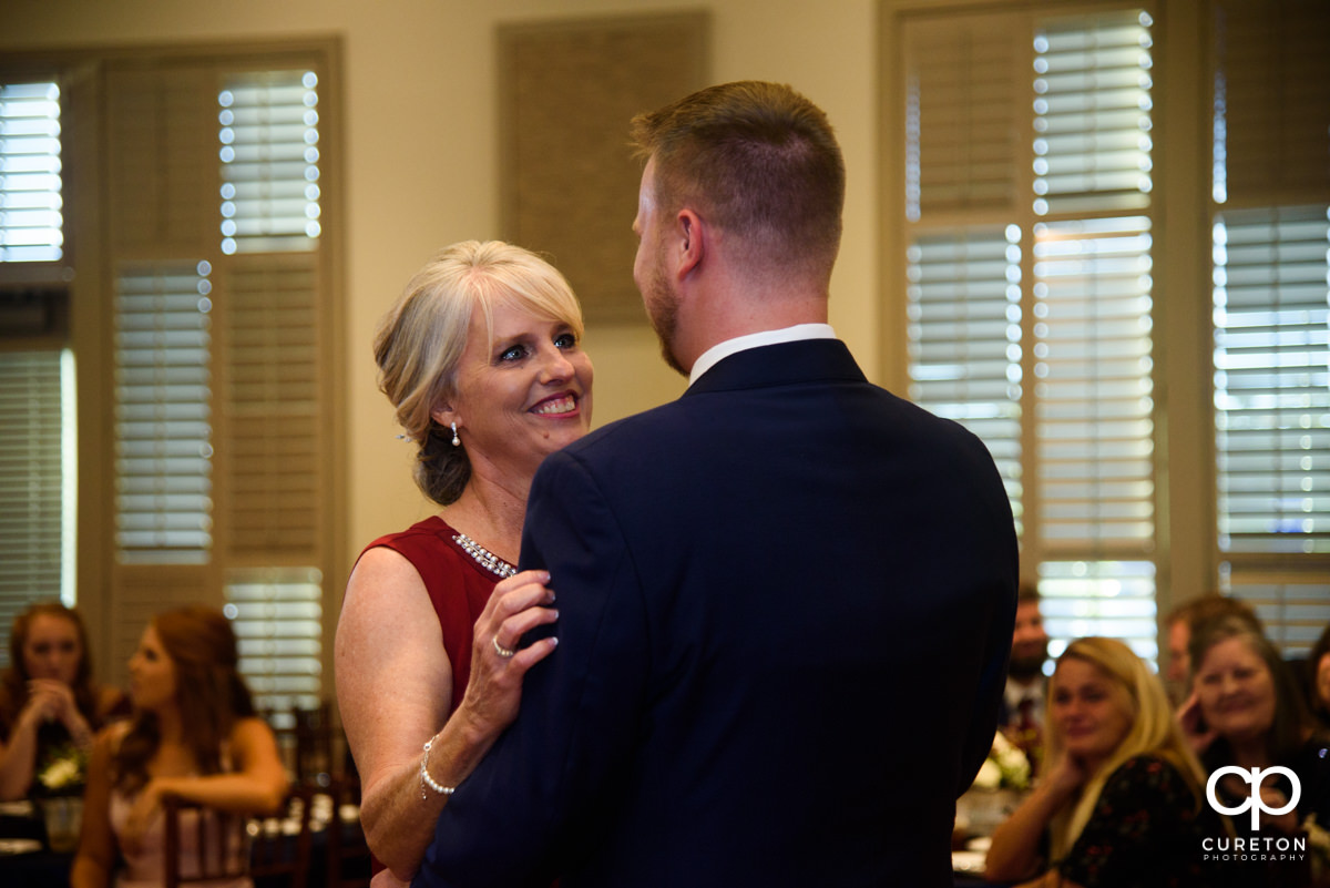 Groom dancing with his mom at the reception.