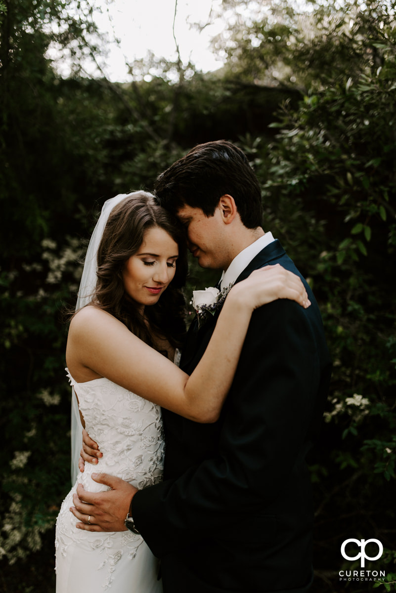 Bride and groom cuddling after their wedding at Noah's Event Venue in Greenville,SC.