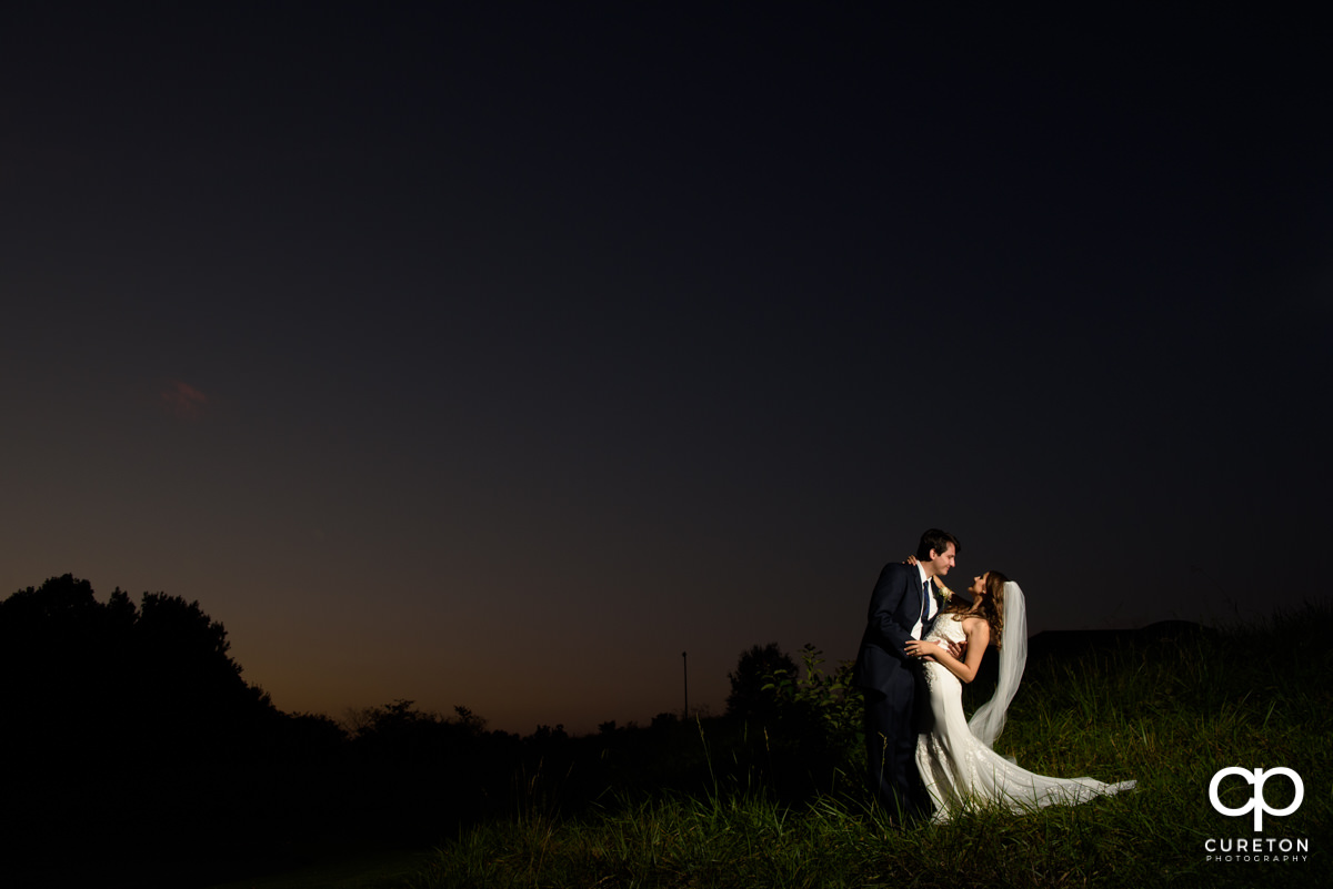 Brode and groom dancing at sunset after their wedding at Noah's Event Venue in Greenville,SC.