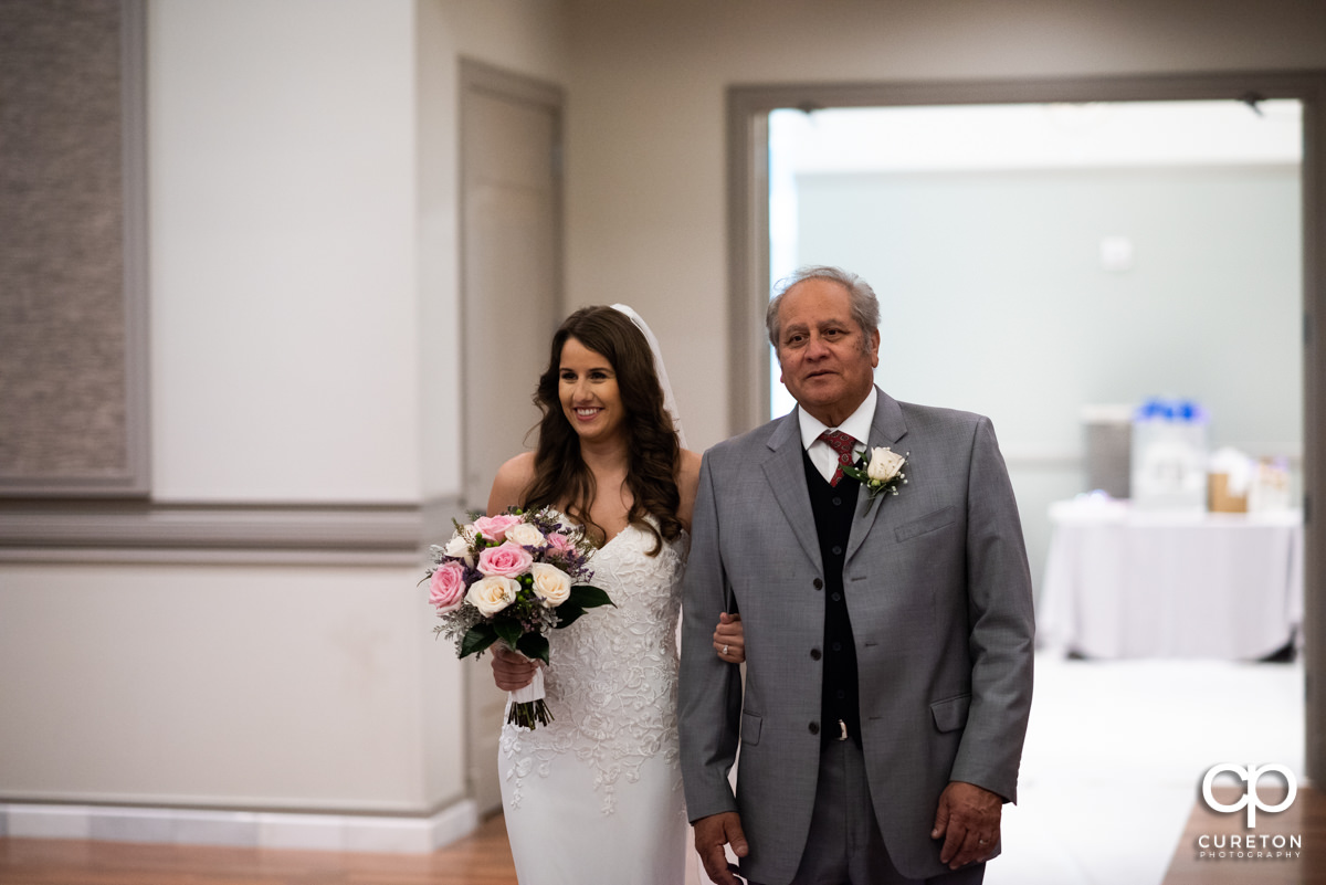 Bride and her father making an entrance into the ceremony.