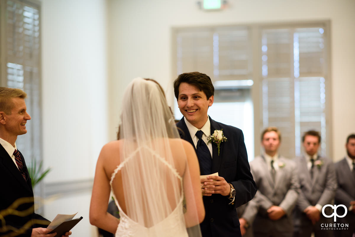 Groom smiling during the wedding ceremony.