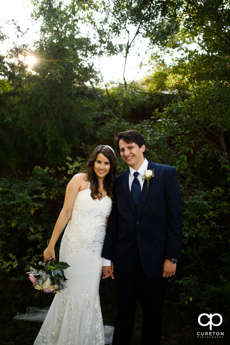 Bride and groom holding hands.